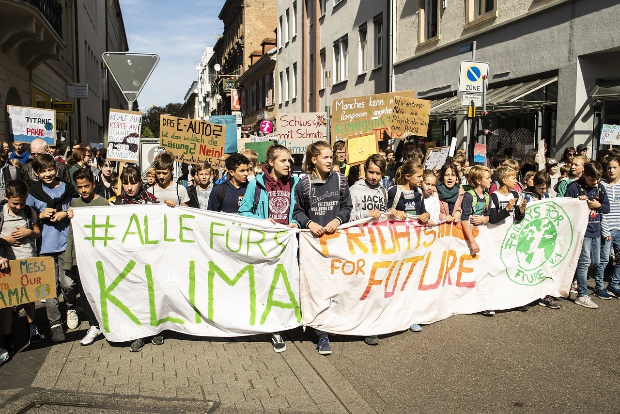Das Foto zeigt eine Klima-Demonstration mit jungen Menschen. Auf dem Frontbanner steht: "Alle fürs Klima"